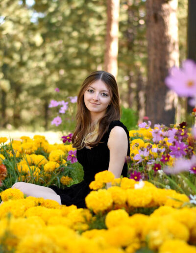 senior photo of girl surrounded by flowers