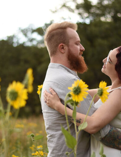 looking at each other with flowers around