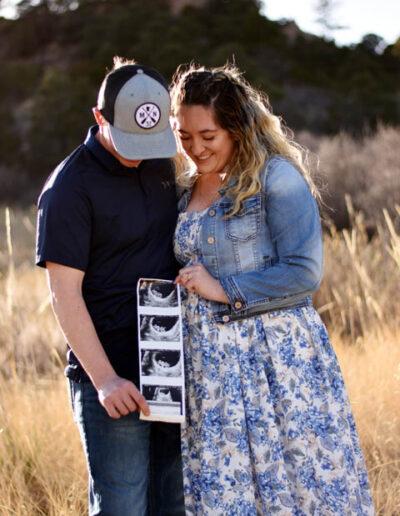 couple with picture of new baby