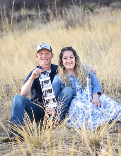 couple with picture of new baby