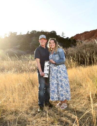 couple with picture of new baby