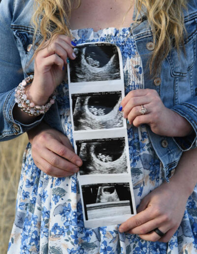 couple with picture of new baby