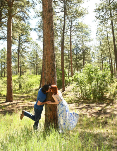 engagement photos kissing by tree