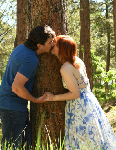 engagement photos kissing by tree