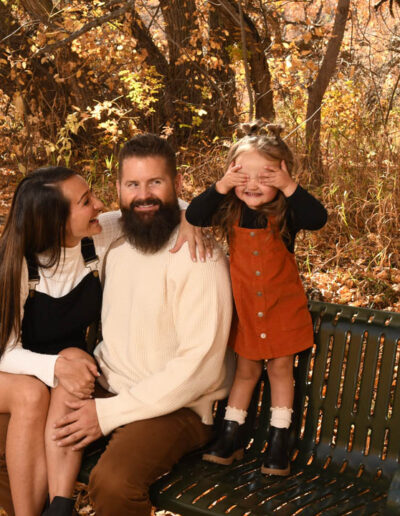 parents with little girl on bench